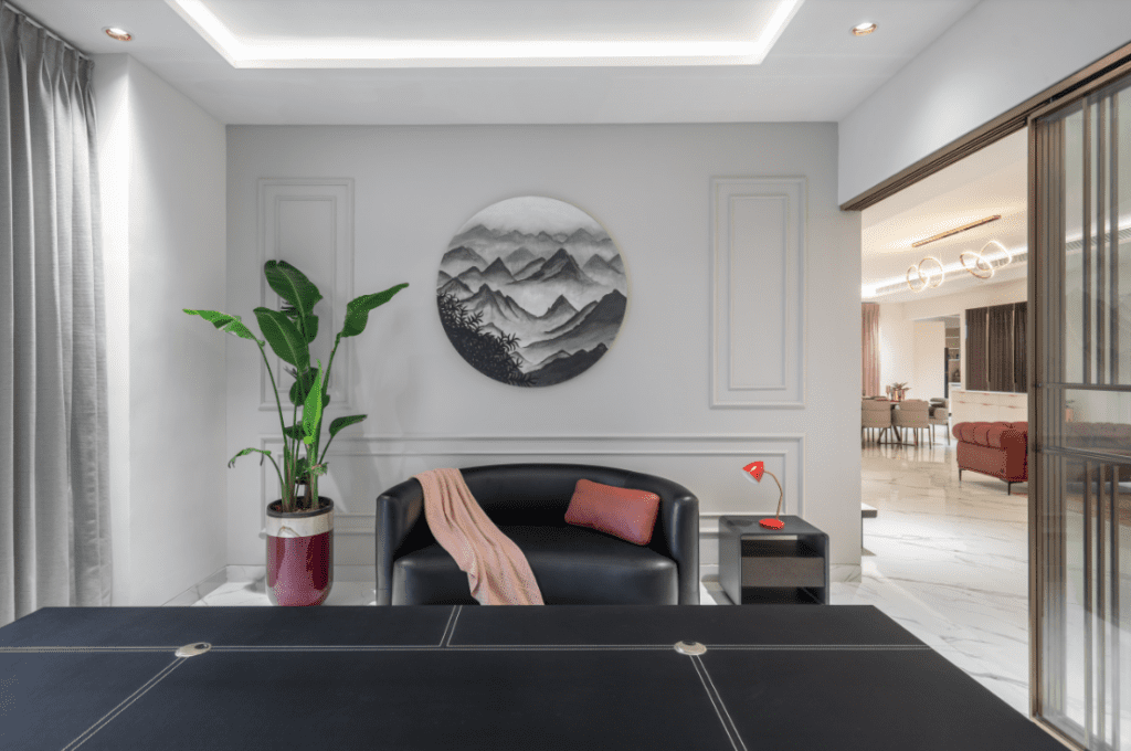 Home office design with black leather chair and mountain wall art in Pune