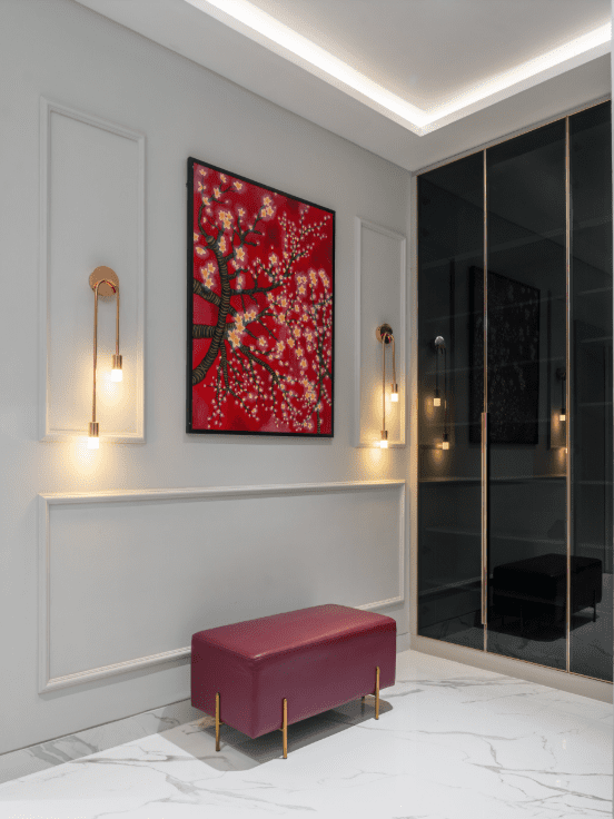 Passage corner design with maroon leather bench and wall-mounted art in Pune
