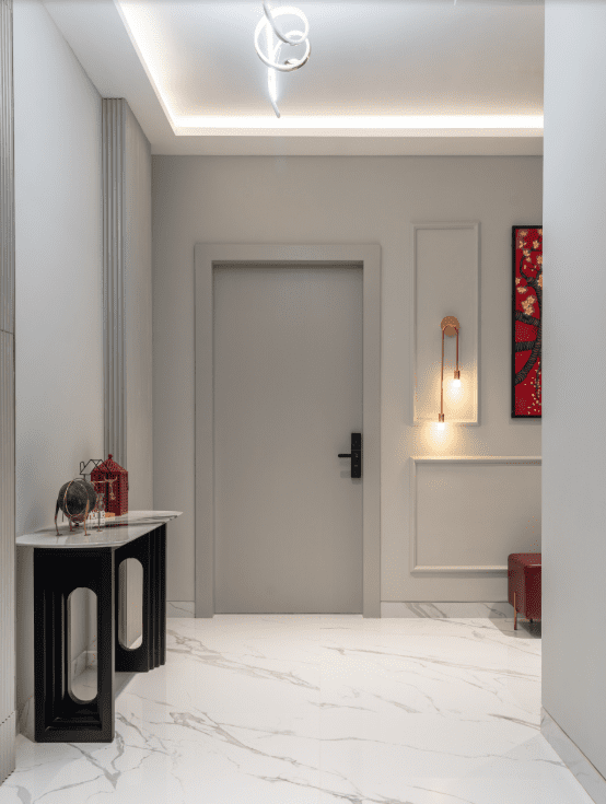 Foyer entrance design with black console table and paneled walls in Pune