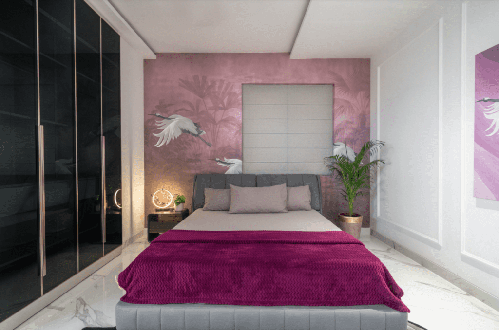 Bedroom design with pink crane-motif wallpaper and dark glossy wardrobes in Pune