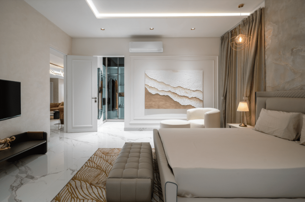 Master bedroom design with walk-in wardrobe view and textured wall art in Pune