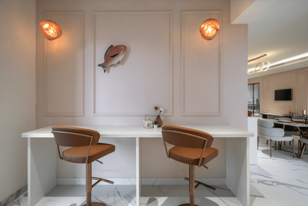Breakfast counter design with tan leather bar chairs and decorative pendant lights in Pune
