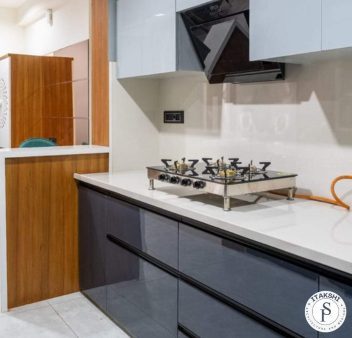 Modern kitchen interior design and wooden panel by Itakshii Designs Pune