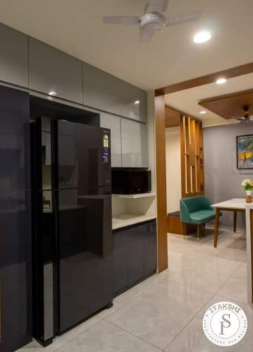 Modern kitchen interior design and wooden panel by Itakshii Designs Pune